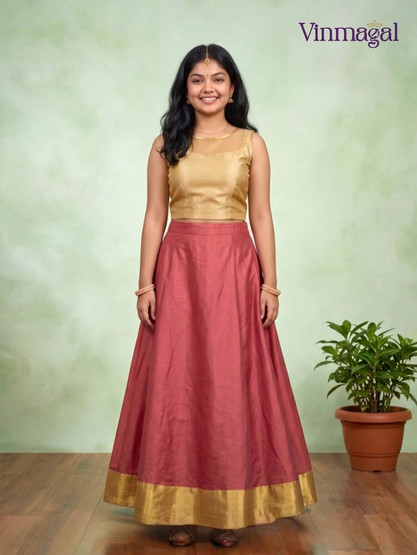golden top with pink kerala pattu pavadai for girls