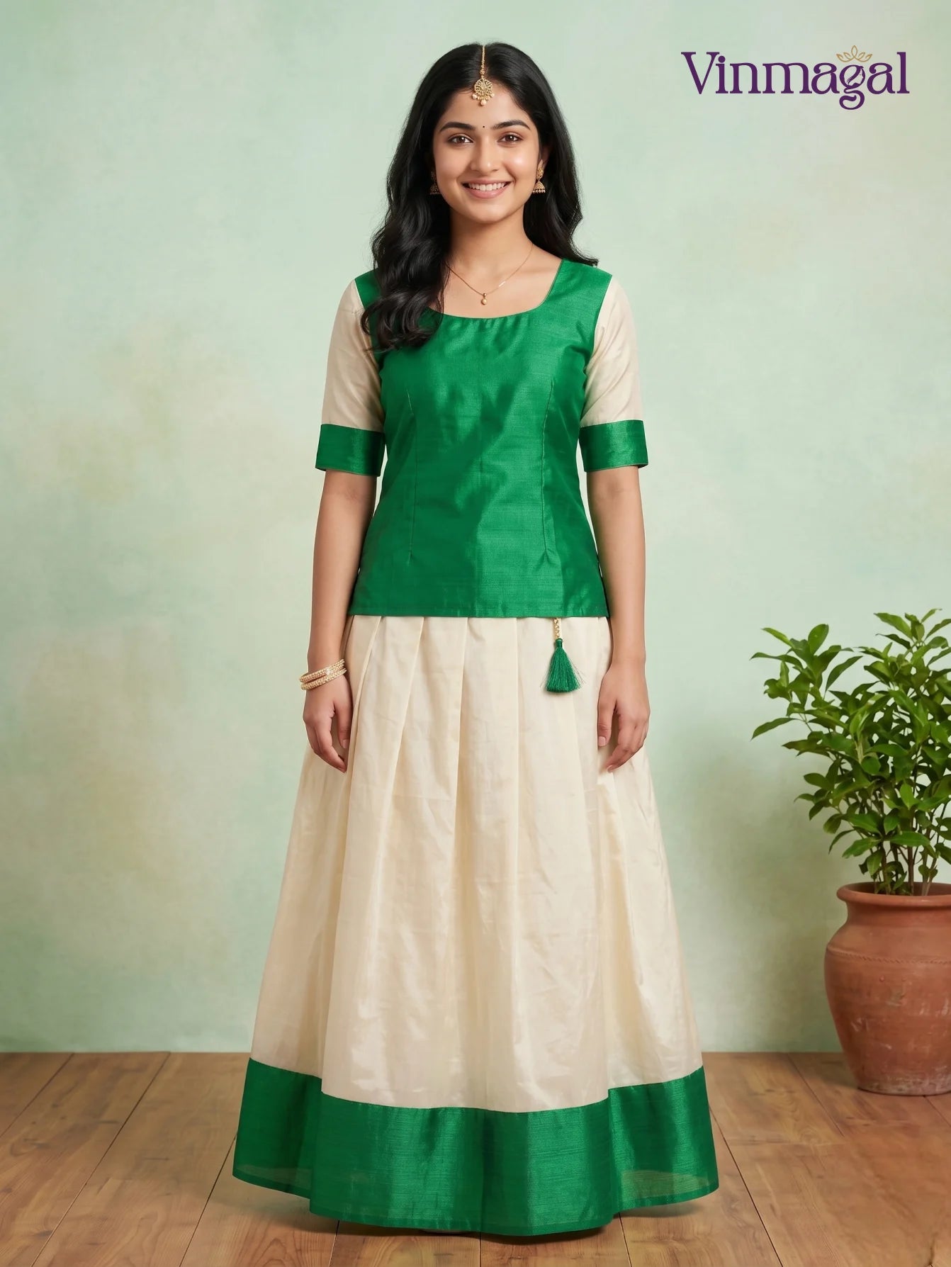 green top with cream white kerala pattu pavadai featuring green border for girls