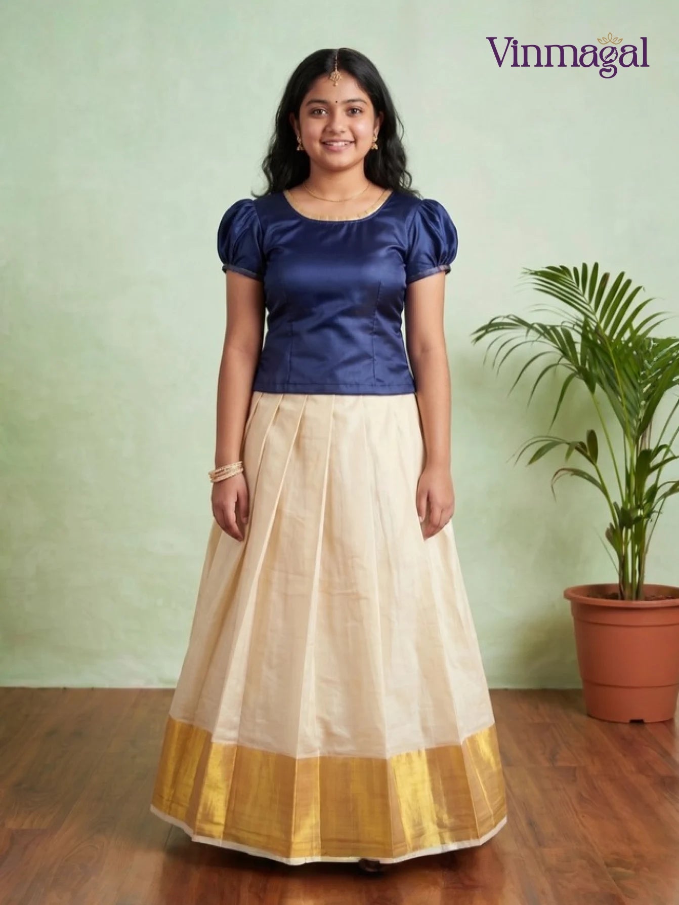 indigo puff sleeve top with cream white kerala pattu pavadai featuring golden border for girls
