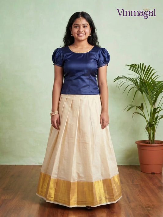 indigo puff sleeve top with cream white kerala pattu pavadai featuring golden border for girls