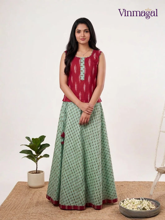 maroon ikkat print top with pastel green cotton pavadai for girls in traditional style