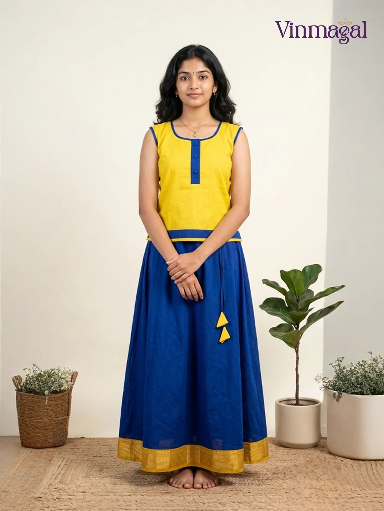 yellow top with blue pattu pavadai for girls suitable for festive wear